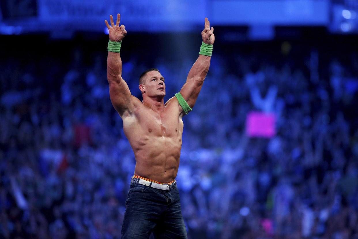 FILE- John Cena celebrates his win during Wrestlemania XXX in New Orleans on April 6, 2014. Cena has been revealed as this year's WWE 2K23 video game cover star. The wrestling game is out Tuesday, March 14, 2023. (Jonathan Bachman/AP Images for WWE, File)