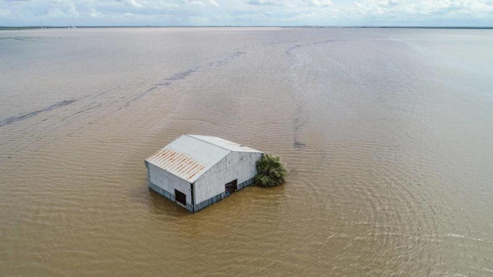 A barn sits in floodwater in the old Tulare Lake basin area of Kings County south of Corcoran on Thursday, March 23, 2023.