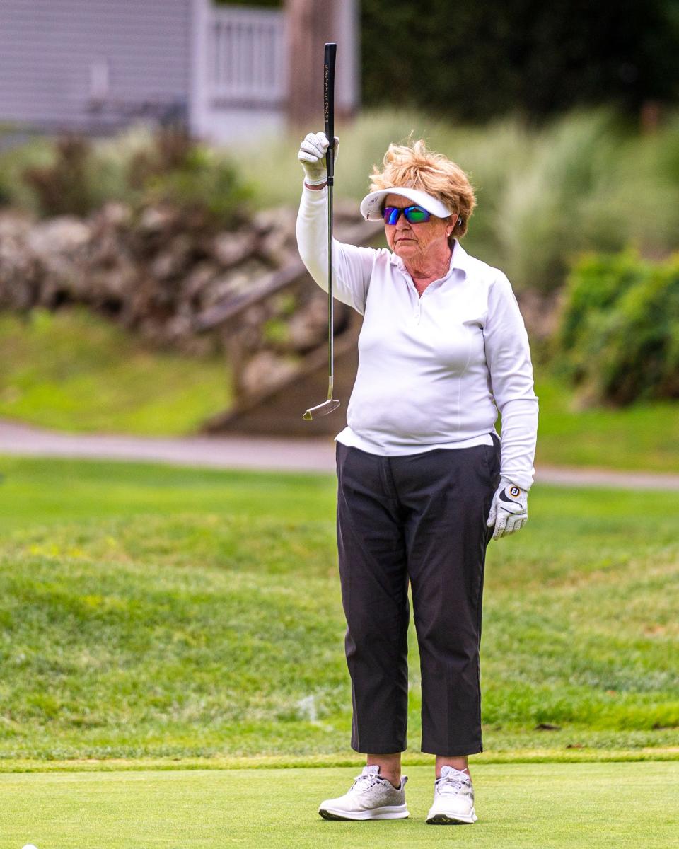 Diane LaCoste lines up her putt on the green on hole 12 at the CCNB Women's Fourball Tournament.