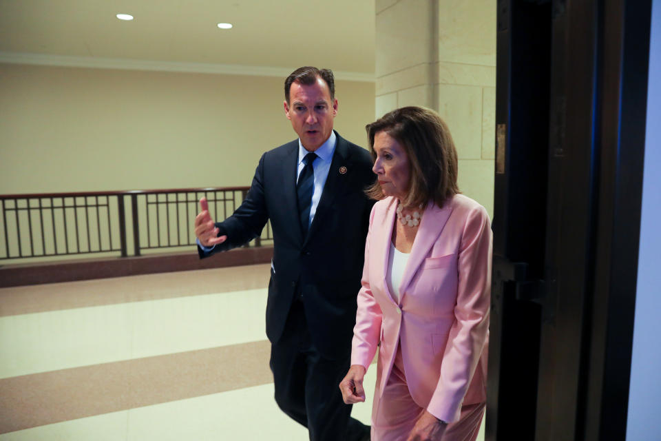U.S. House Speaker Nancy Pelosi (D-CA) speaks with Rep. Tom Suozzi (D-NY) as she arrives for her weekly news conference on Capitol Hill in Washington, U.S. September 12, 2019.  REUTERS/Jonathan Ernst
