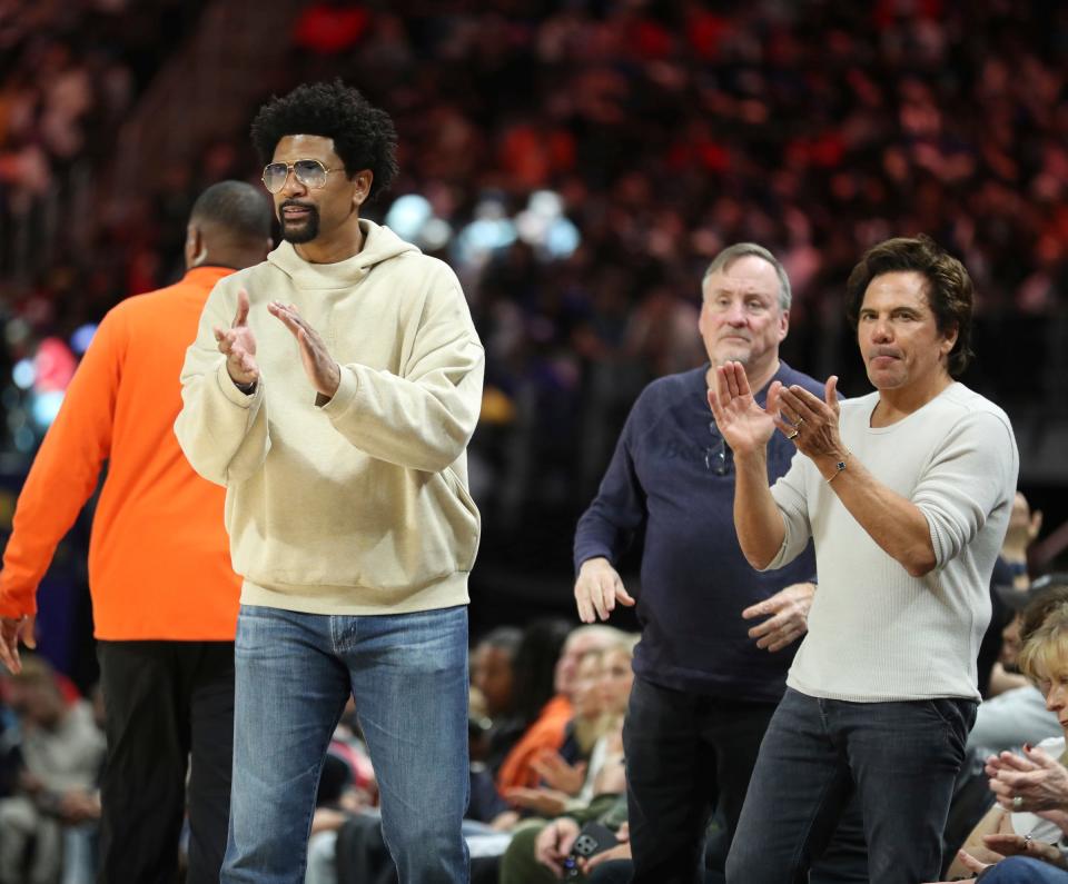Jalen Rose, left, and Pistons owner Tom Gores, right, watch the action against the Phoenix Suns at Little Caesars Arena in Detroit on Sunday, Nov. 5, 2023.