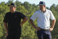 Sungjae Im, of South Korea, and Scottie Scheffler stand on the 18th green during their fourball match at the Presidents Cup golf tournament at the Quail Hollow Club, Friday, Sept. 23, 2022, in Charlotte, N.C. (AP Photo/Chris Carlson)