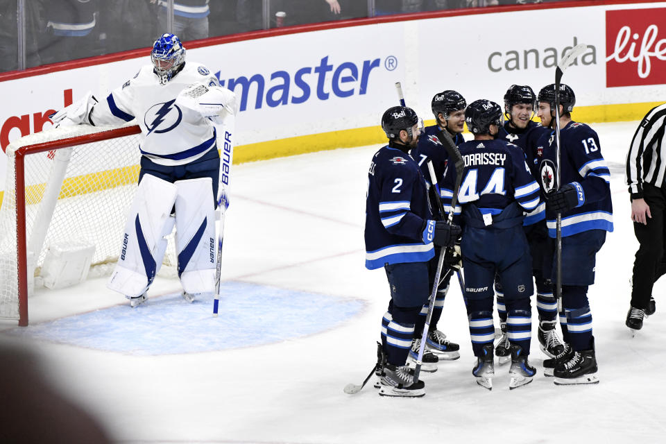 Winnipeg Jets' Nikolaj Ehlers, second from right, celebrates his goal against the Tampa Bay Lightning with teammates during the third period of an NHL hockey game Tuesday, Jan. 2, 2024, in Winnipeg, Manitoba. (Fred Greenslade/The Canadian Press via AP)