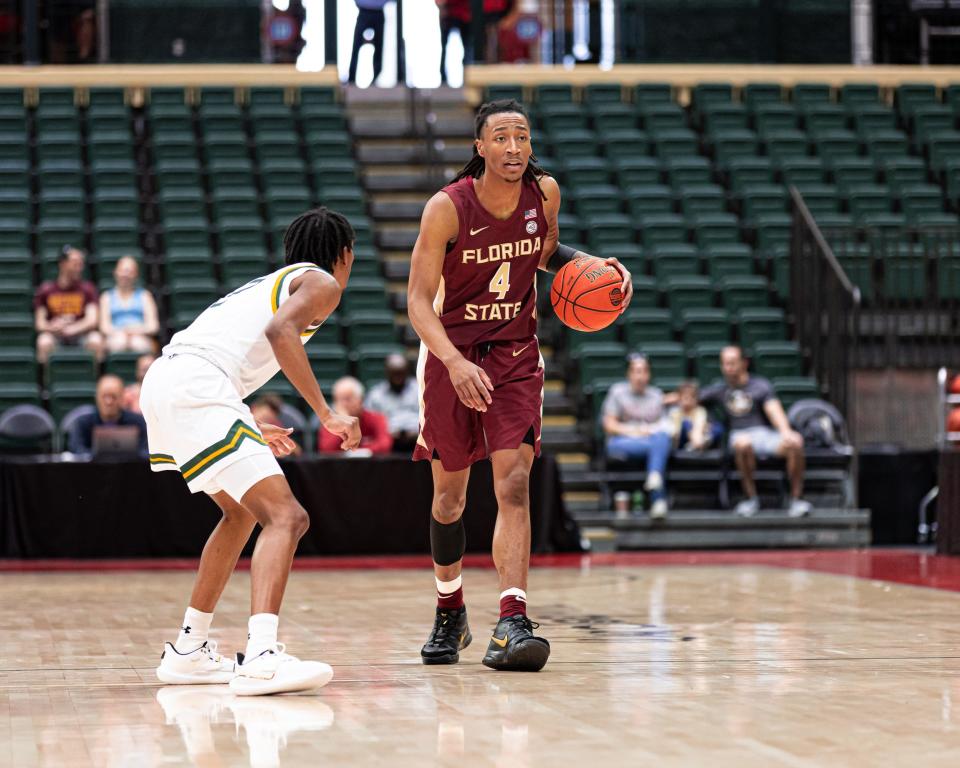 Florida State men's basketball guard Caleb Mills brings the ball up the court in a loss to Siena.