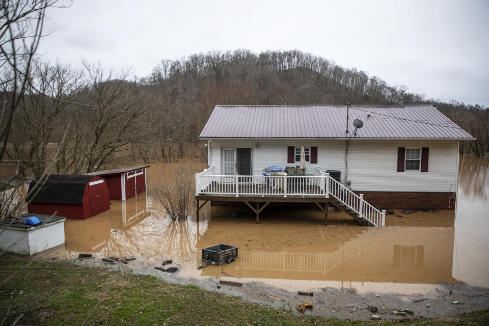 Floodwater surrounds a home along Charleys Creek Road on Friday, Feb. 17, 2023, in Milton, W.Va. (Kyle Phillips/The Herald-Dispatch via AP)