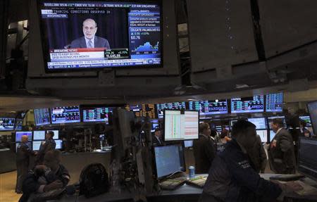 Traders work at their posts as a news conference of U.S. Federal Reserve Board Chairman Ben Bernanke is broadcast on the floor of the New York Stock Exchange, September 18, 2013. The Federal Reserve said on Wednesday that it would continue buying bonds at an $85 billion monthly pace for now, expressing concerns that a sharp rise in borrowing costs in recent months could weigh on the economy. REUTERS/Brendan McDermid