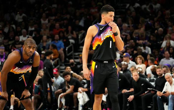 May 15, 2022; Phoenix, Arizona, USA; Phoenix Suns guard Chris Paul (3) and guard Devin Booker (1) reacts against the Dallas Mavericks during game seven of the second round for the 2022 NBA playoffs at Footprint Center.