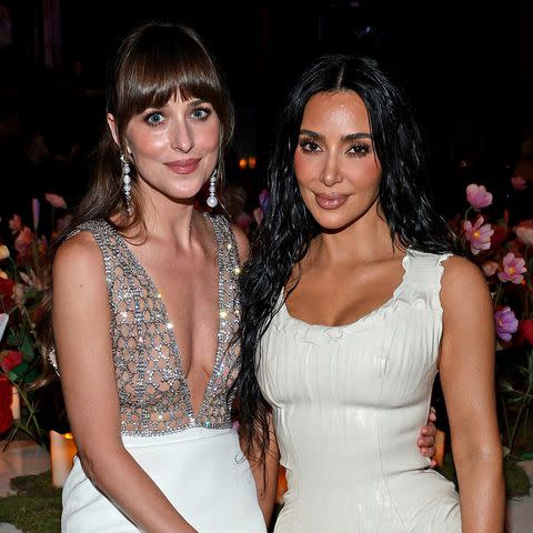 <p>Dimitrios Kambouris/Getty</p> Dakota Johnson and Kim Kardashian