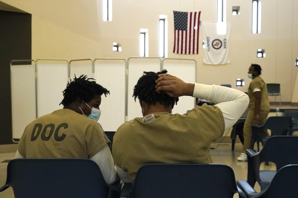 Inmates at the Cook County, Ill., jail wait to register and vote in a local election at the jail's Division 11 Chapel on Saturday, Feb. 18, 2023, in Chicago. (AP Photo/Charles Rex Arbogast)