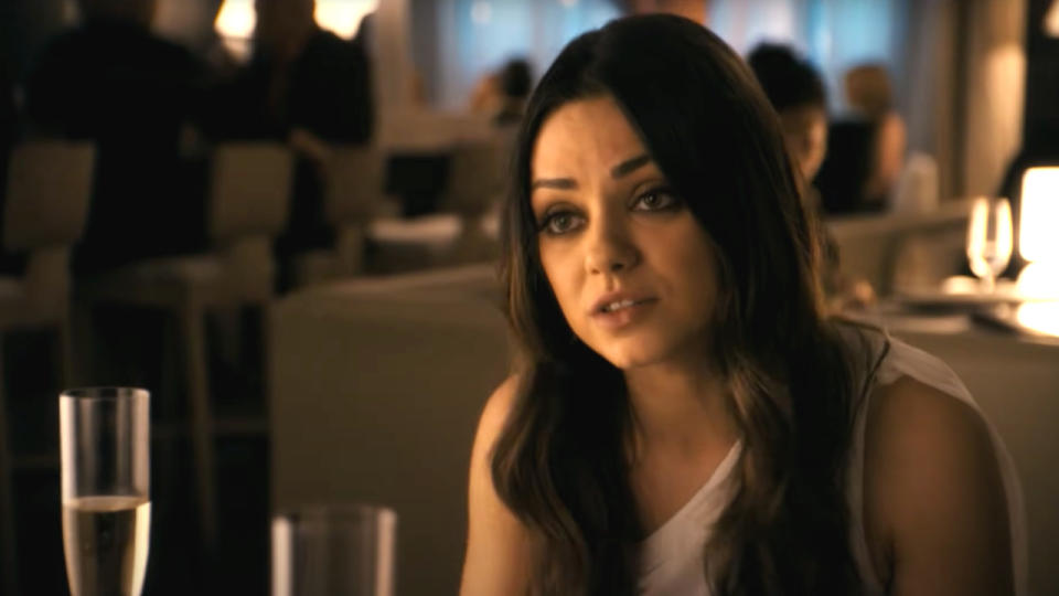 Mila Kunis sitting down to dinner in Ted.