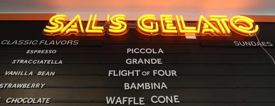 A neon sign lights up over the menu board at Sal's Gelato.