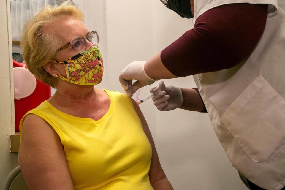 Pharmacist Ivelisse vaccinates Rita Boggenan, of Delray Beach, at the Fresco y Más supermarket at 19091 SW 137th Ave. in Miami on Feb. 11, 2021. She drove an hour and a half to get her vaccine because she was not able to find appointments closer to her home. 