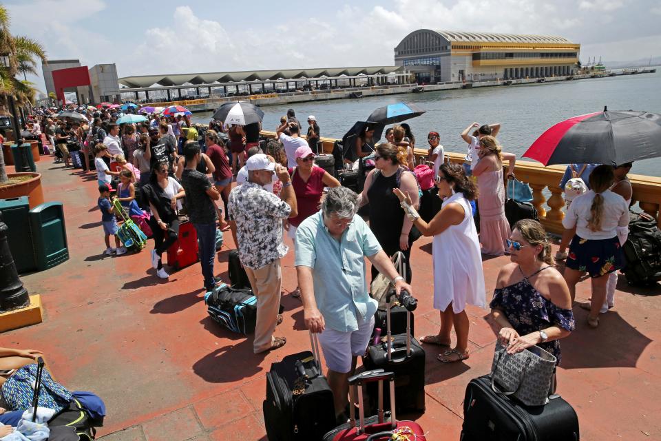 Thousands of Puerto Rican evacuees lined up for a cruise ship in the aftermath of Hurricane Maria in San Juan, Puerto Rico, in September 2017. The aftermath of the powerful storm resulted in a near-total shutdown of the U.S. territory's economy and had many worried about their financial survival on the storm-ravaged island.