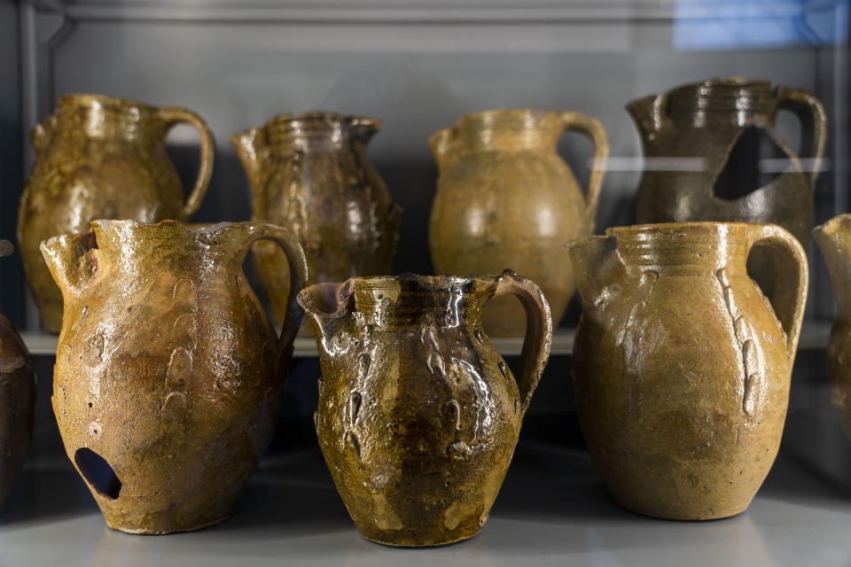 Jugs found in the Roman Forum are on display in what had been commercial spaces part of 1st century Emperor Tiberius' palace complex in Rome, Wednesday, April 19, 2023. The pieces, today on display at the Forum, were part of the myriads of findings still kept in the Colosseum storehouse that is not open to the public. (AP Photo/Domenico Stinellis)