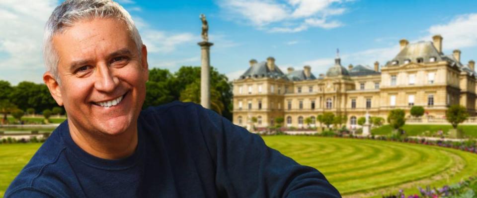 Handsome middle age man outdoor portrait with a Paris cityscape background.