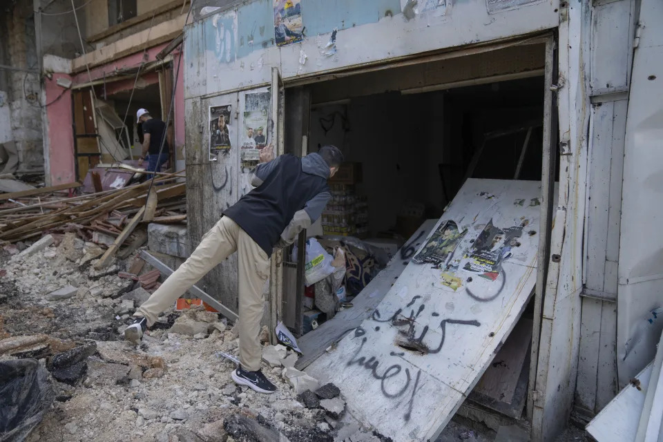 Palestinians inspect the damaged shops in the West Bank refugee camp of Nur Shams, Tulkarem, Sunday, April 21, 2024. The Palestinian Red Crescent rescue service meanwhile said it has recovered more than a dozen of bodies from an Israeli raid in the Nur Shams urban refugee camp in the West Bank that began late Thursday. Those killed include three militants from the Islamic Jihad group and a 15-year-old boy. (AP Photo/Nasser Nasser)