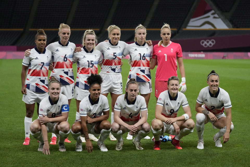 Britain team pose for a group photo prior to women's soccer match against Japan at the 2020 Summer Olympics, Saturday, July 24, 2021, in Sapporo, Japan. (AP Photo/Silvia Izquierdo)