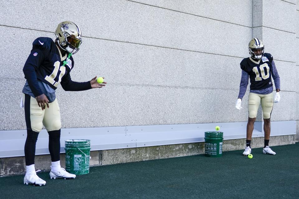 New Orleans Saints' Deonte Harty and Tre'Quan Smith warms up before an NFL football joint practice session with the Green Bay Packers Tuesday, Aug. 16, 2022, in Green Bay, Wis. (AP Photo/Morry Gash)