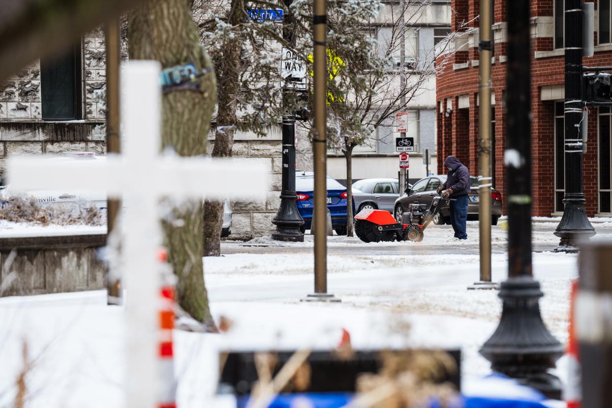 A city worker is seen February 11, 2021 using a power sweeper to clear ice across in Louisville, Kentucky. The National Weather Service credited the onslaught of sleet and snow to a polar vortex phenomenon.