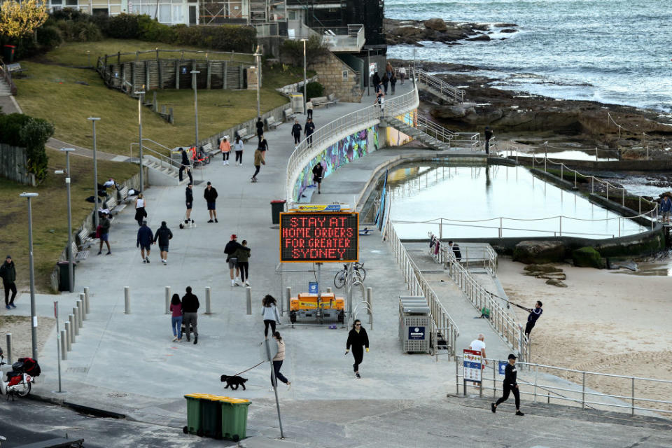 Walkers at Bondi beach.