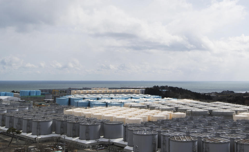 This photo shows tanks (in gray, beige and blue) storing water that was treated but still radioactive after it was used to cool down spent fuel at the Fukushima Daiichi nuclear power plant in Okuma town, Fukushima prefecture, northeastern Japan, Saturday, Feb. 27, 2021. (AP Photo/Hiro Komae)