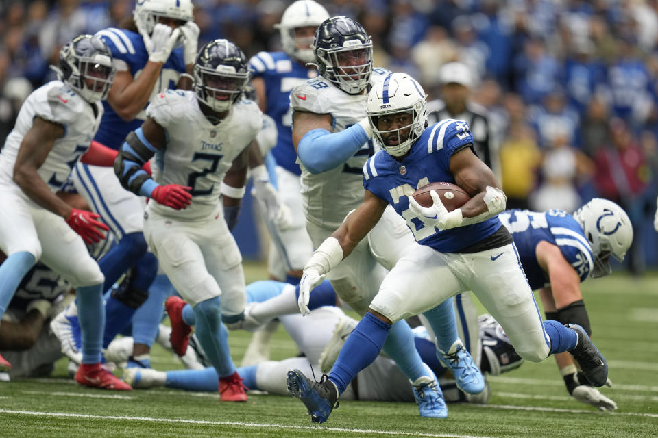 Indianapolis Colts running back Zack Moss, runs the ball past the Tennessee Titans' defense during the second half of an NFL football game, Sunday, Oct. 8, 2023, in Indianapolis. (AP Photo/Michael Conroy)