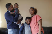 In this photo taken Sept. 24, 2019, Yonas Yeshanew, left, who resigned as Ethiopian Airline's chief engineer this summer and is seeking asylum in the U.S., poses with his family, including wife Tigist Hailu and sons Nathan Yonas, 1, and Yoel Yonas, 5, in Seattle area. Yeshanew says in a whistleblower complaint filed with regulators that the carrier went into the maintenance records on a Boeing 737 Max jet a day after it crashed this year, a breach he contends was part of a pattern of corruption that included fabricating documents, signing off on shoddy repairs and even beating those who got out of line. (AP Photo/Elaine Thompson)