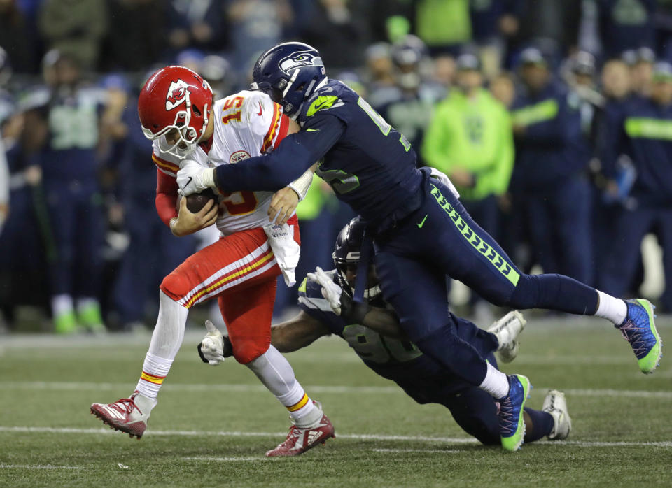 Kansas City Chiefs quarterback Patrick Mahomes (15) is tackled by Seattle Seahawks defensive end Frank Clark. (AP Photo/Stephen Brashear)