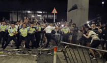 FILE - In this Monday, June 10, 2019, file photo, police officers use pepper spray against protesters in a rally against the proposed amendments to the extradition law at the Legislative Council in Hong Kong. What began as a protest against an extradition bill has ballooned into a fundamental challenge to the way Hong Kong is governed _ and the role of the Chinese government in the city’s affairs. (AP Photo/Vincent Yu, File)