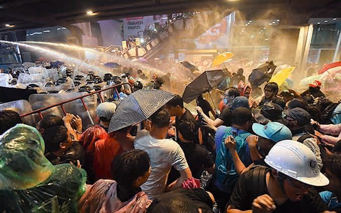 Riot police use water cannons to disperse pro-democracy protesters during an anti-government rally near Pathum Wan intersection October 16, 2020 in Bangkok, Thailand - Getty 