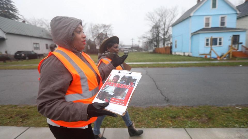 Kareema Morris and Content Adams distributed flyers for a missing teen on Chelsea Place in Buffalo on Dec. 18, 2021. Jaylen Griffin, 13, had been missing for a year.