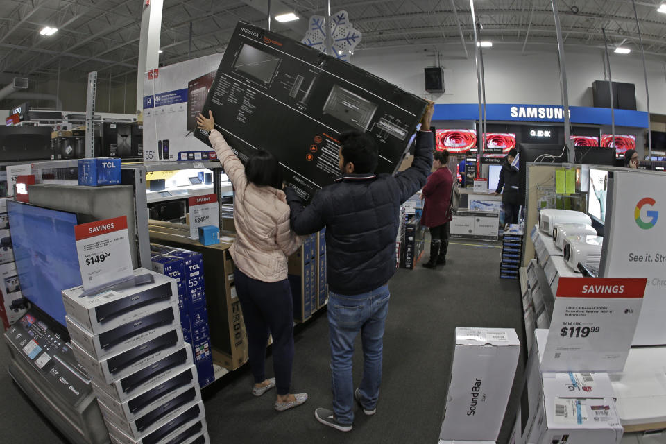 People shop at a Best Buy store during a Black Friday sale Thursday, Nov. 28, 2019, in Overland Park, Kan. (AP Photo/Charlie Riedel)