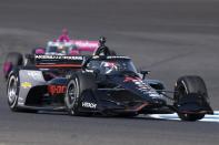 Josef Newgarden drives into a turn during a practice session for the IndyCar Grand Prix auto race at Indianapolis Motor Speedway, Friday, May 10, 2024, in Indianapolis. (AP Photo/Darron Cummings)