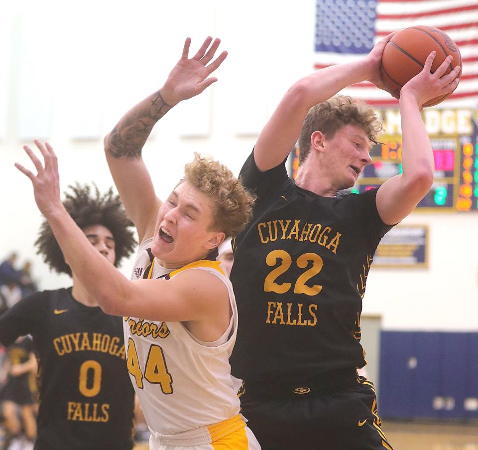 Cuyahoga Falls' Drew Huffman grabs a rebound over Walsh Jesuit's Grant Blascak on Wednesday, Dec. 27, 2023, in Tallmadge, Ohio, at the Tallmadge Winter Classic. [Phil Masturzo/ Beacon Journal]