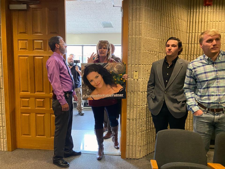 Rhonda Nail holds up a photo of her daughter Katie Palmer at the door of the district courtroom where the hearing was held Friday in the attempt to remove Grayson County Judge Bill Magers from office.