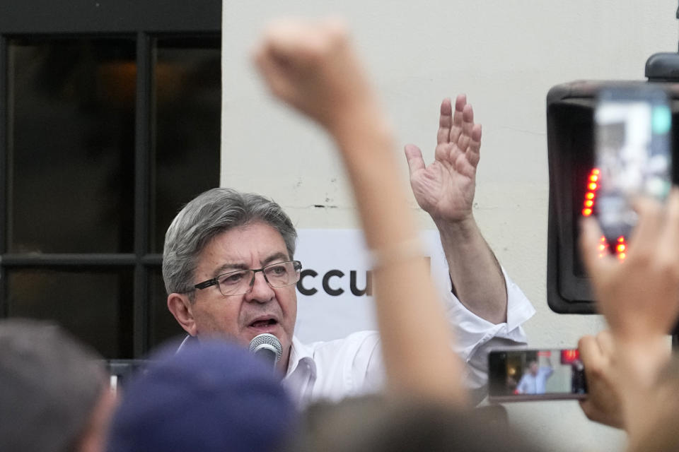 Hard-left leader Jean-Luc Melenchon speaks to supporters outside his election night headquarters, Sunday, June 19, 2022 in Paris. French President Emmanuel Macron's alliance got the most seats in the final round of the parliamentary election on Sunday, but it lost its parliamentary majority, projections show. (AP Photo/Michel Euler)