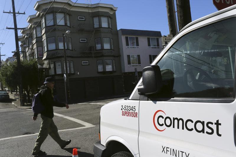 A Comcast sign is shown on the side of a vehicle in San Francisco, California February 13, 2014. REUTERS/Robert Galbraith