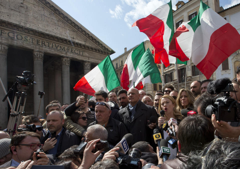 FILE — Giorgia Meloni talks with reporters in Rome's Pantheon Square, Wednesday, March 16, 2016. With God, homeland and "natural" family prominent in her political manifesto, Giorgia Meloni, whose Fratelli d'Italia (Brothers of Italy) party with neo-fascist roots has been fast rising in popularity in view of the upcoming Sept. 25 elections for Parliament, is positioning herself to become Italy's first far-right premier and the first woman to hold that office. (AP Photo/Alessandra Tarantino)