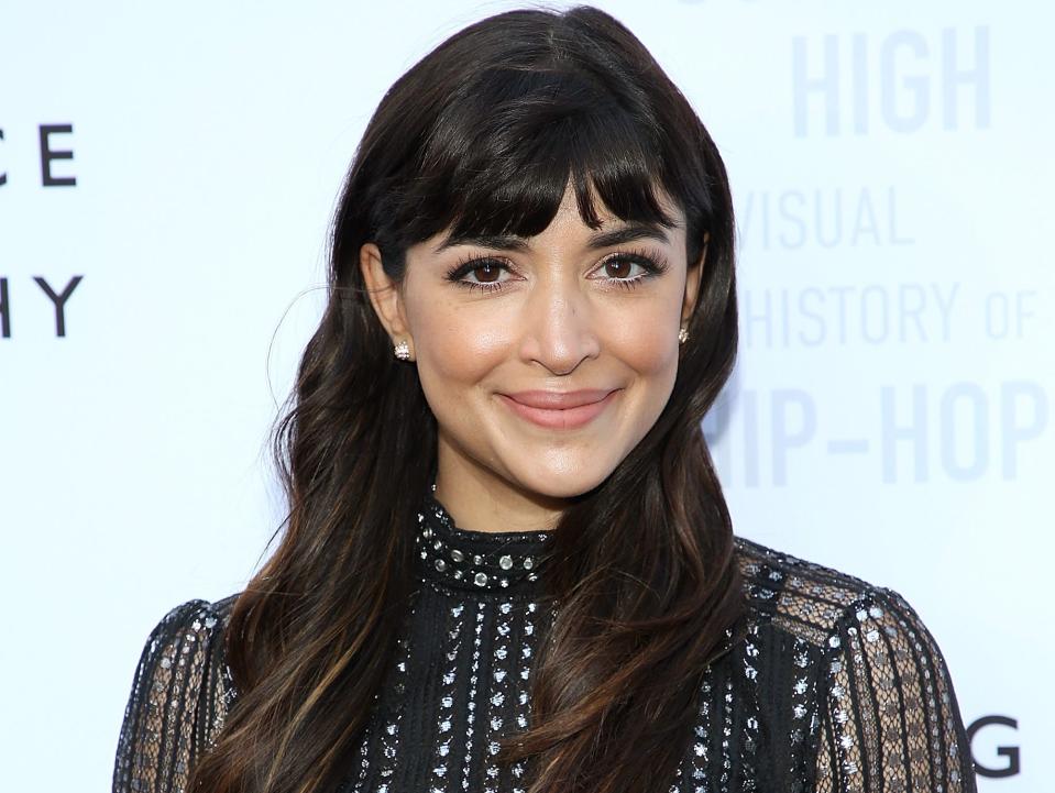 Hannah Simone with black dress and silver details