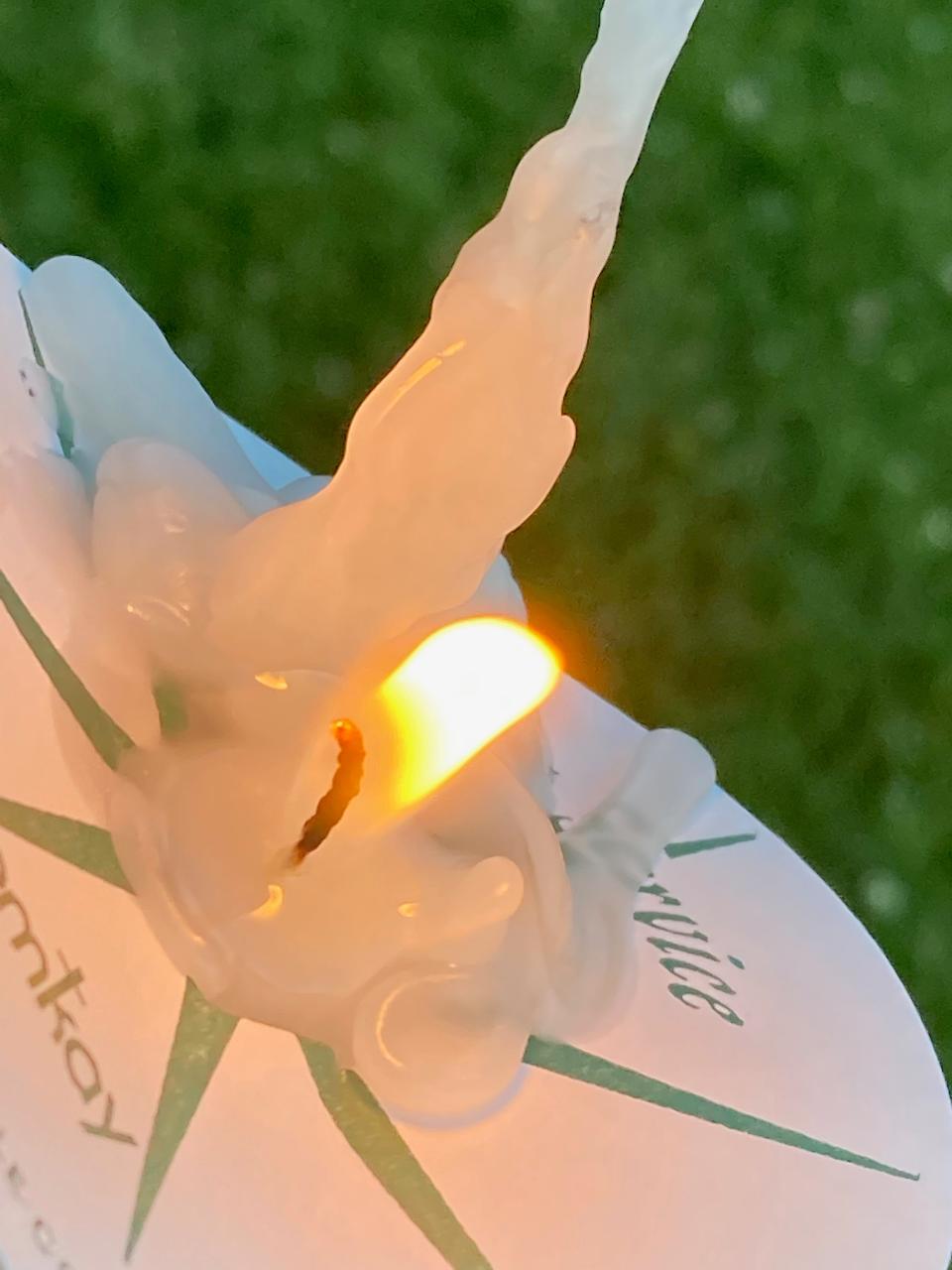 A candle burns during a Saturday night vigil for the victims of the June 9 shootings near Smithsburg. More than 100 people attended the vigil at Lions Community Park, maybe 3/10ths of a mile from the manufacturing business where four people were shot.