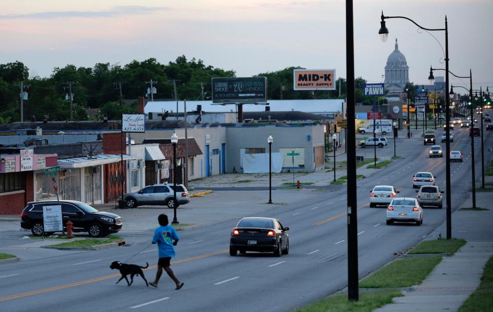 Traffic and pedestrians move along NE 23rd Street in Oklahoma City on June 10, 2015.