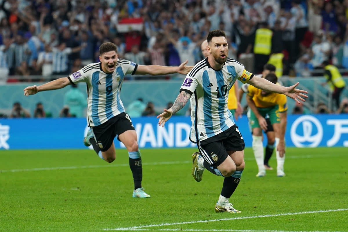 Lionel Messi, right, celebrates after firing Argentina into a first-half lead against Australia (Martin Rickett/PA) (PA Wire)