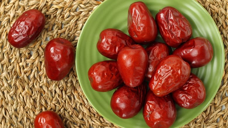 Top-down view of Chinese dates on a green plate