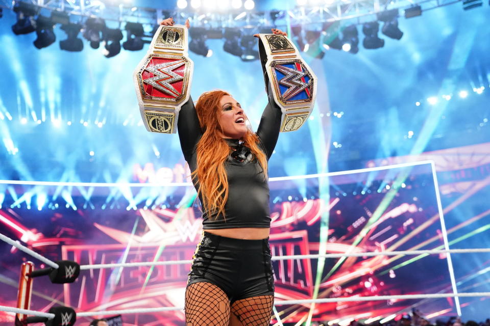 Becky Lynch celebrates after winning both the Raw and Smackdown women's championships at WrestleMania 35 at MetLife Stadium in East Rutherford, N.J. (WWE)