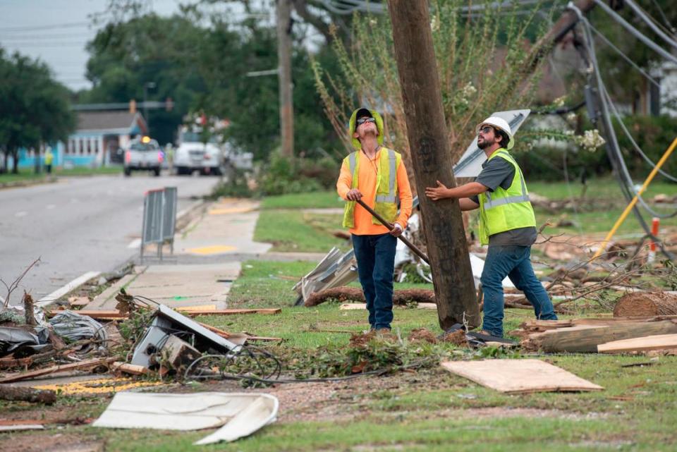 Mississippi Power workers reinstall telephone poles in Moss Point on Tuesday, June 20, 2023, after a tornado tore through the town on Monday, knocking out power to thousands.