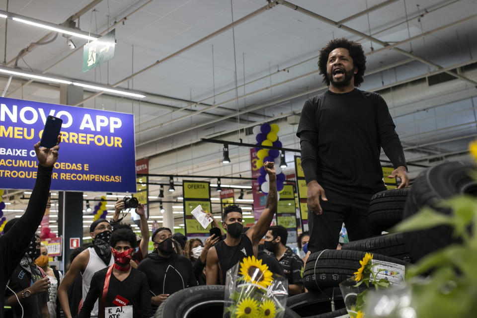 Activists including members of Black Lives Matter demonstrate inside a Carrefour supermarket against the murder of Black man Joao Alberto Silveira Freitas at a different Carrefour the night before, on Brazil's National Black Consciousness Day in Rio de Janeiro, Brazil, Friday, Nov. 20, 2020. Freitas died after being beaten by supermarket security guards in the southern Brazilian city of Porto Alegre, sparking outrage as videos of the incident circulated on social media. (AP Photo/Bruna Prado)