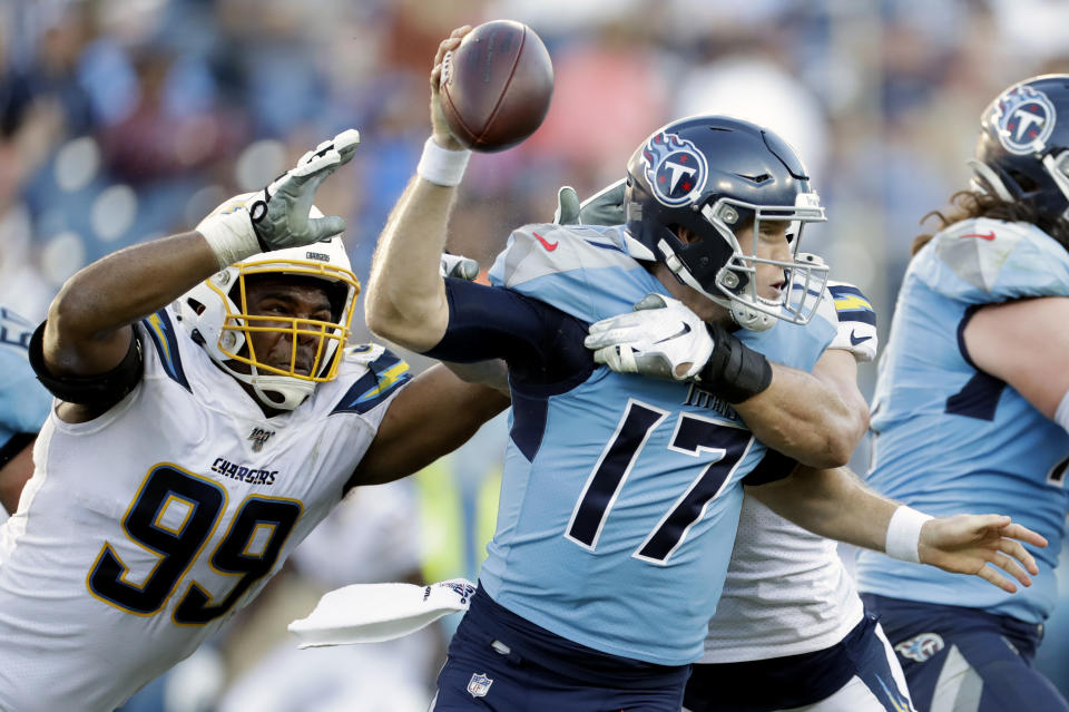 Tennessee Titans quarterback Ryan Tannehill (17) is sacked by Los Angeles Chargers defensive end Joey Bosa and defensive tackle Jerry Tillery (99) in the second half of an NFL football game Sunday, Oct. 20, 2019, in Nashville, Tenn. (AP Photo/James Kenney)