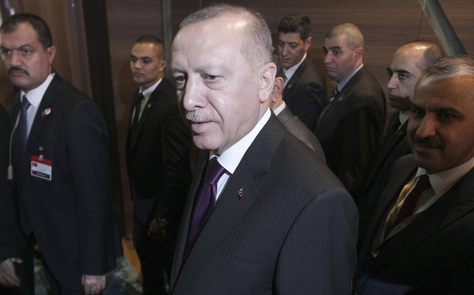 Turkish President Recep Tayyip Erdogan leaves after a meeting with Algerian President Abdelmadjid Tebboune, Sunday, Jan.26, 2020 in Algiers. Turkish President Recep Tayyip Erdogan visited Algeria for talks on the conflict in neighbouring Libya. (AP Photo/Fateh Guidoum)