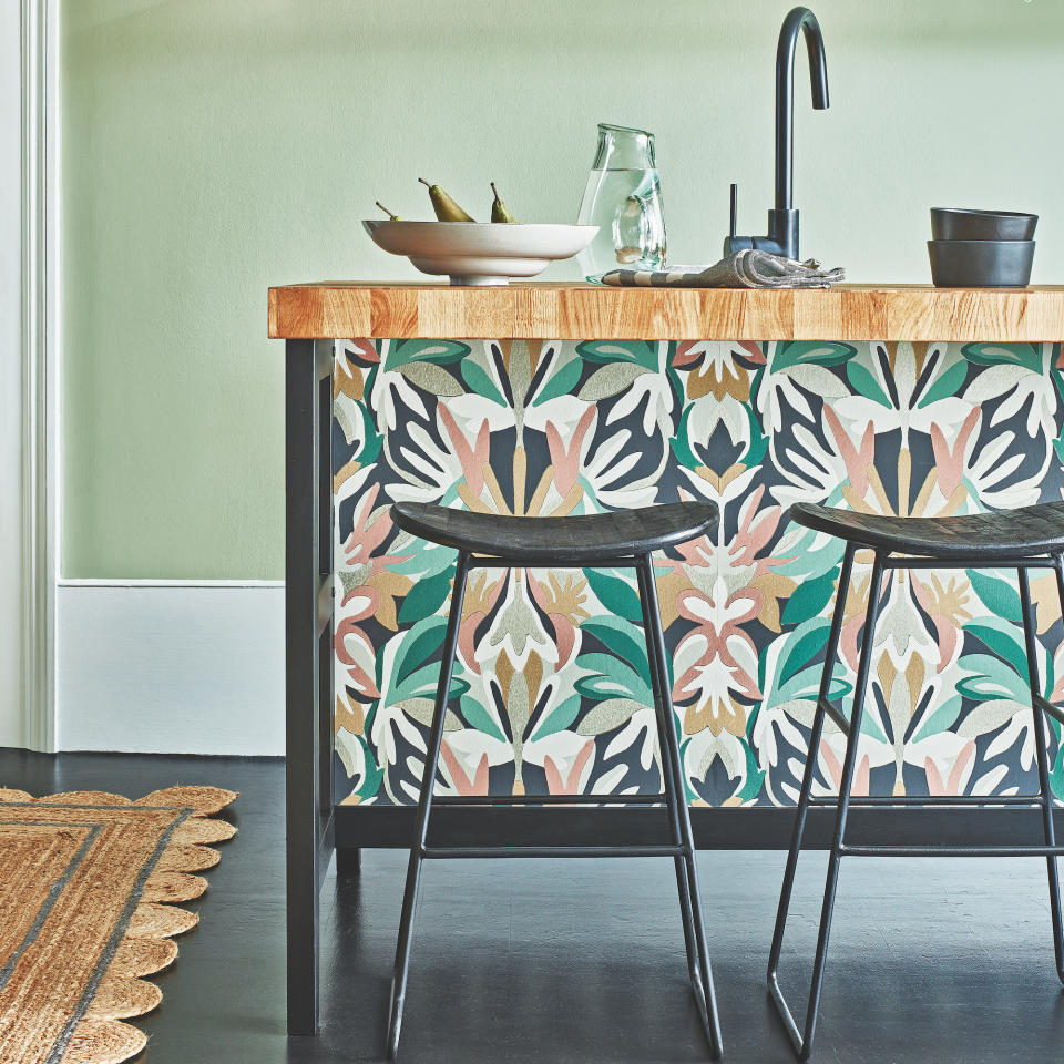 room with floral kitchen table and black tap