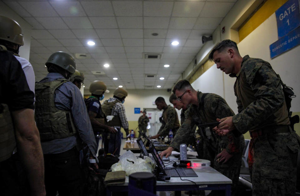 Marines of the 24th Marine Expeditionary Unit (MEU) process Department of State personnel for evacuation at Hamid Karzai International Airport, in Kabul, Afghanistan, Sunday, Aug. 15, 2021. (Sgt. Isaiah Campbell/U.S. Marine Corps via AP)